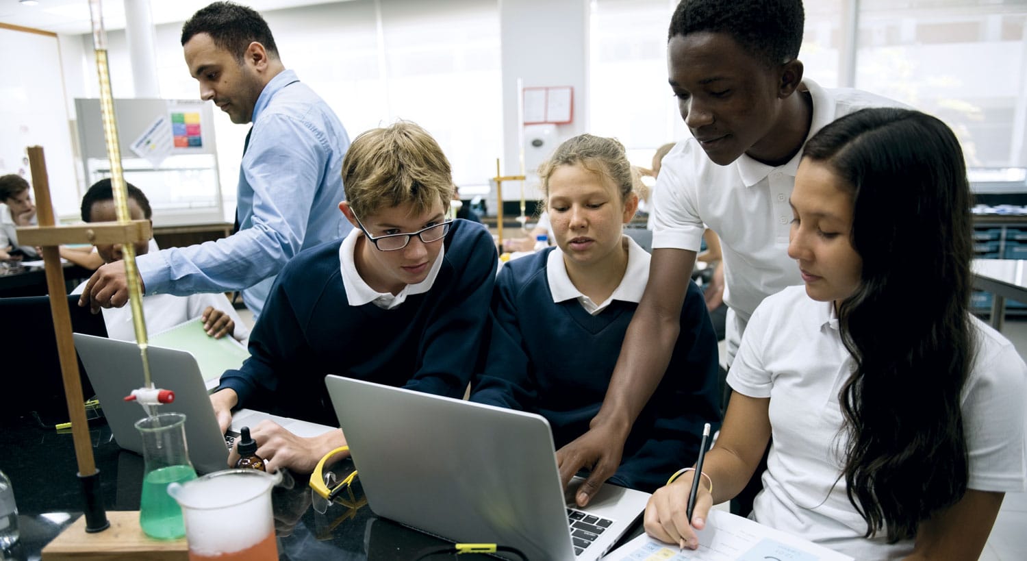 students work together science class laptop