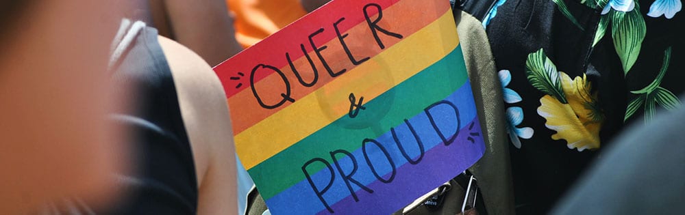 queer and proud sign parade