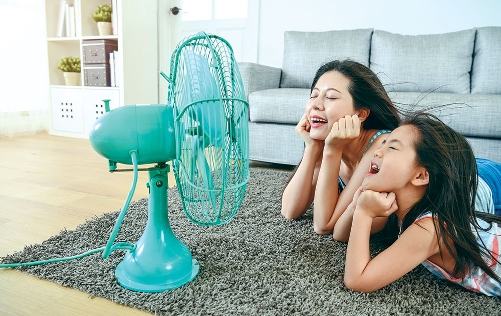 mom daughter hot in front of fan blowing