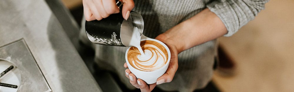 barista making coffee close up