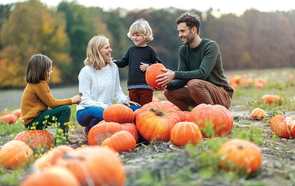 young family at pumpkin patch