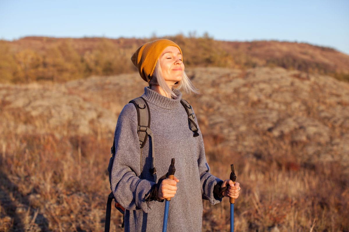 woman with walking poles autumn