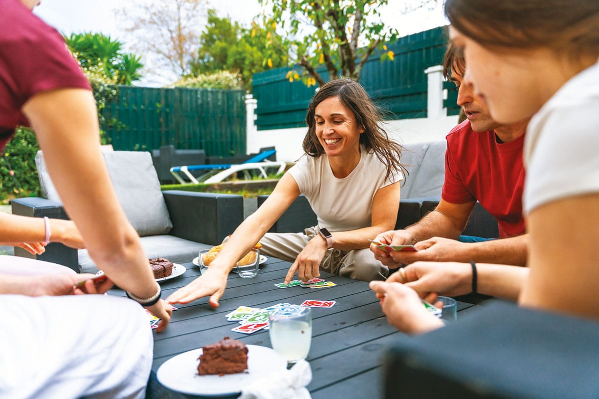 family playing cards outside